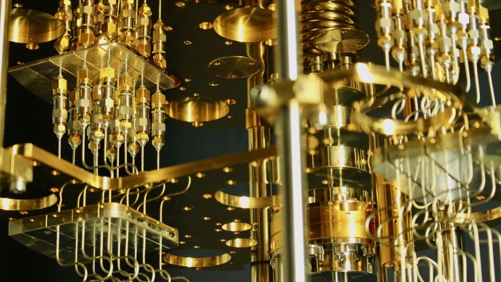 Close-up of a complex gold-plated quantum computer processor and its intricate wiring.
